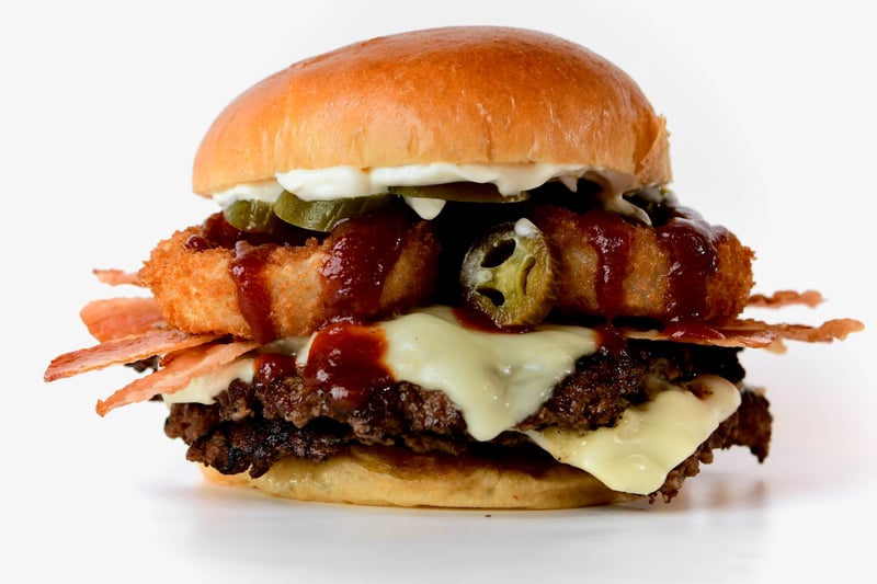 Photo of Cowboy Burger - BBQ bacon burger topped with crispy onion rings, cheddar cheese, and smoky BBQ sauce