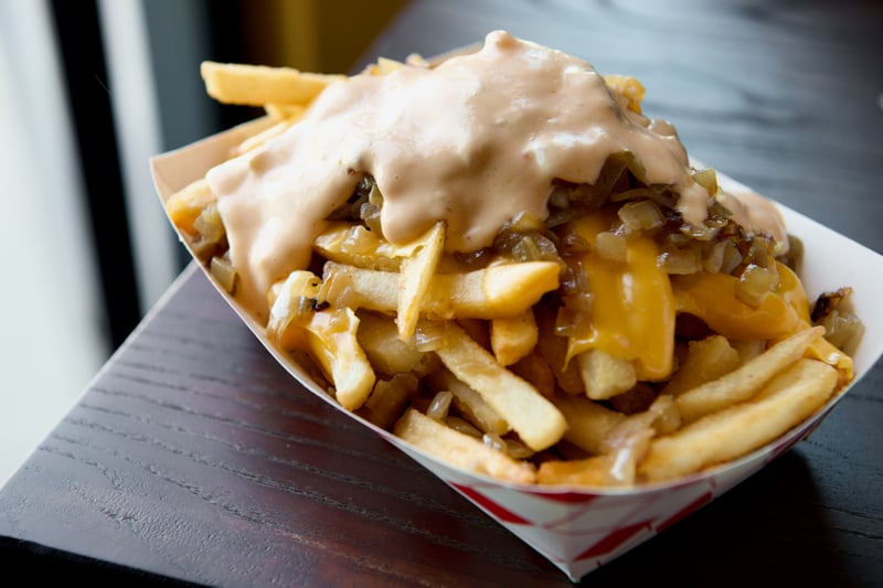 Photo of Crispy's Crazy Fries - Loaded fries with cheese sauce, bacon bits, green onions, and special seasoning